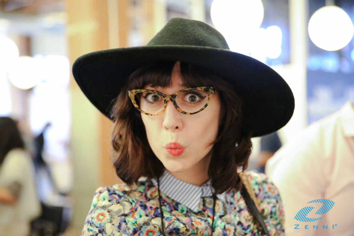 Person wearing tortoiseshell eyeglasses and broad-brimmed black hat. Zenni logo in the bottom right corner.