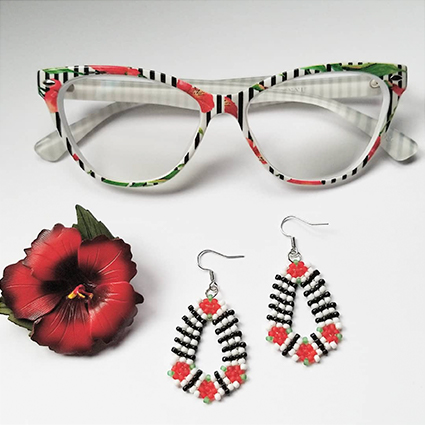 Colorful eyeglasses with floral frames, red flower, and black, red, white beaded drop earrings.