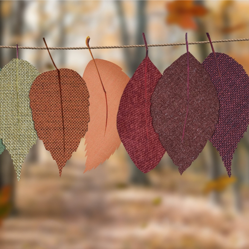 Colorful fabric leaves hanging on a string.