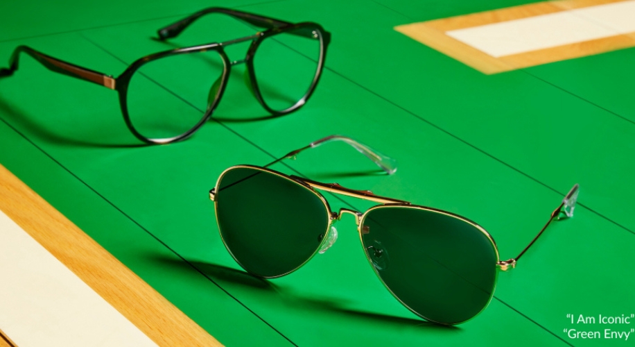 Two pairs of glasses, one aviator-style and one square-frame. Text: "I Am Iconic" "Green Envy".