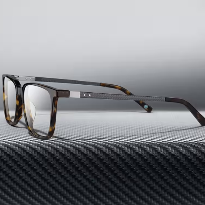 Tortoiseshell rectangular eyeglasses with black carbon fiber temples and metallic accents.