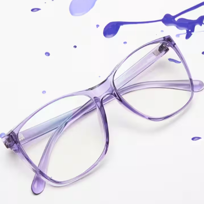 Purple transparent-frame eyeglasses with slight paint splatters nearby.