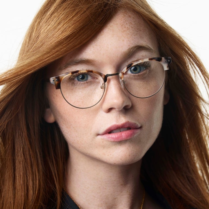 Round tortoiseshell eyeglasses with metallic bridge and temples.