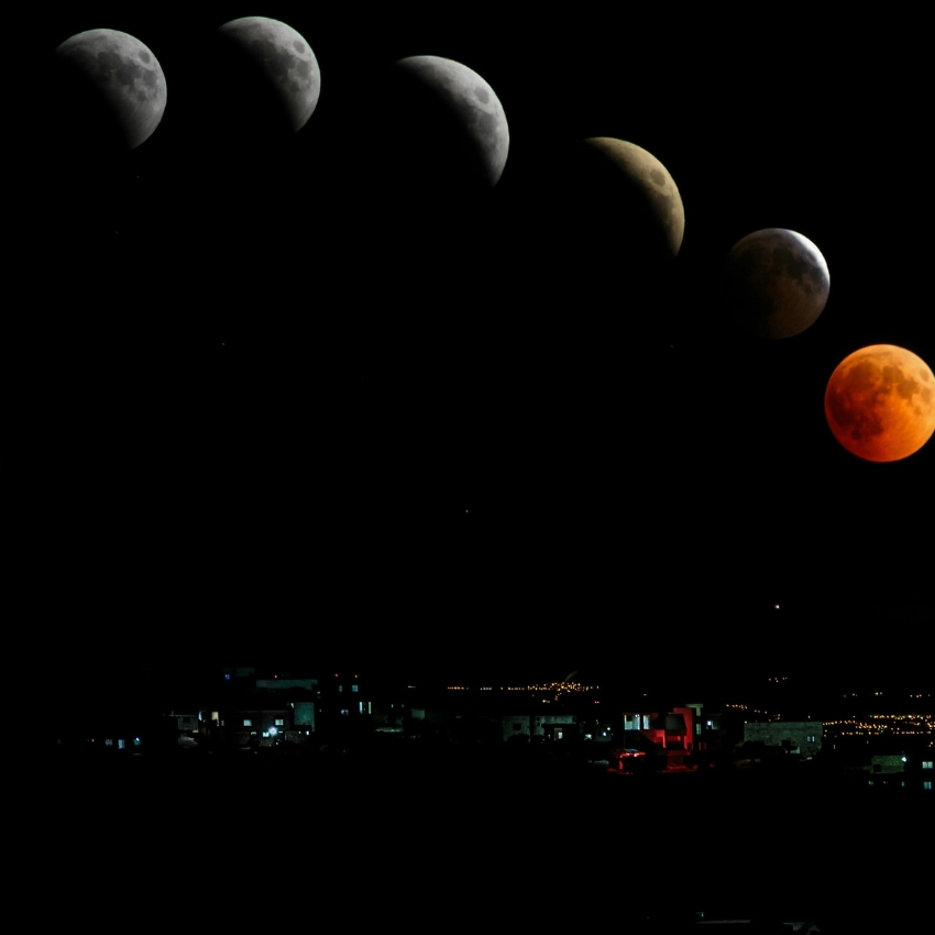 Lunar eclipse phases progressing from a bright full moon to a completely red moon against a night sky.