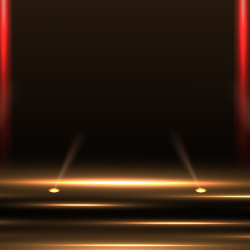 Spotlights shining on a dark stage with red vertical ribbons in the background.