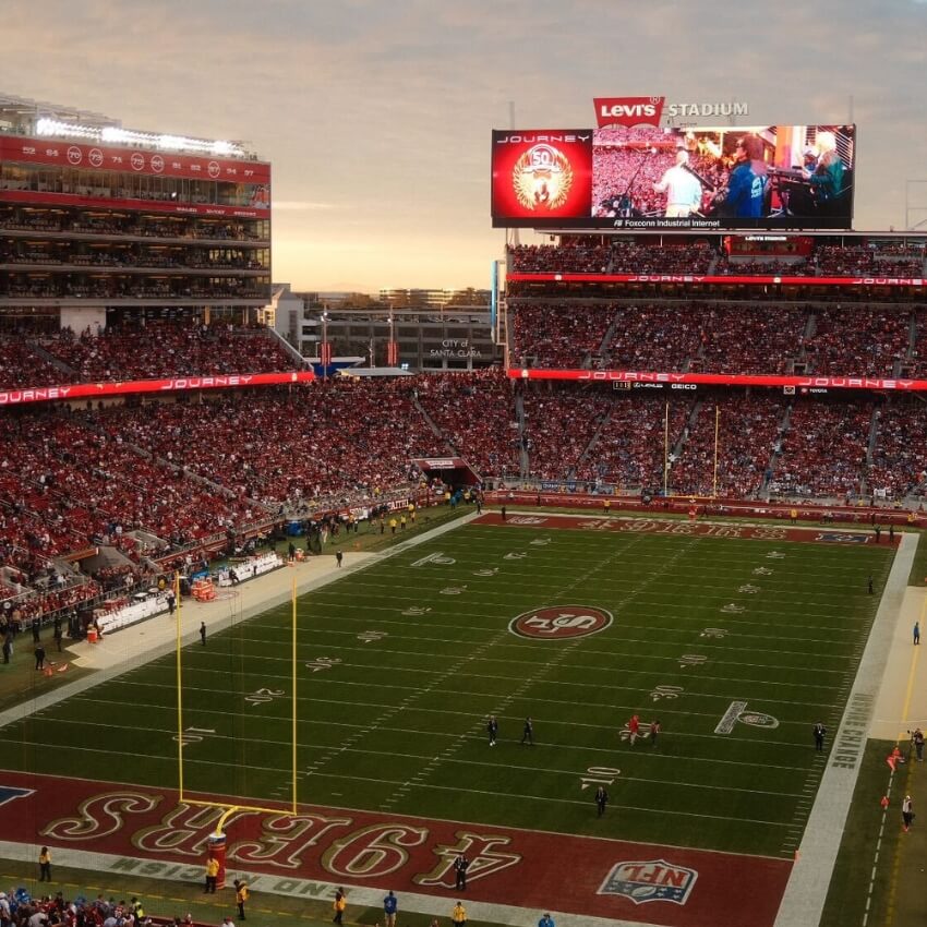 Levi's Stadium showing the end zone with "49ERS" and a scoreboard displaying "Journey 50 Years" during a game.