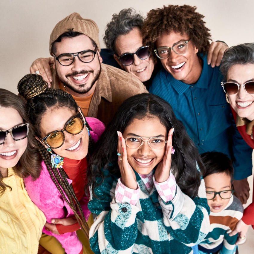 Group of people smiling and wearing stylish eyeglasses and sunglasses.