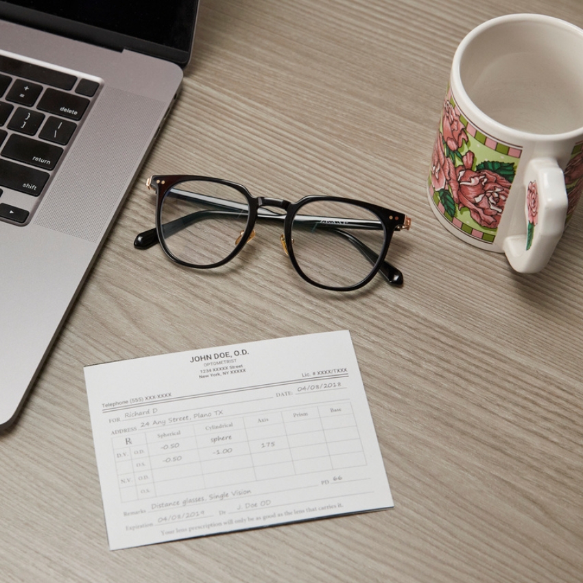 Cat-eye glasses next to a prescription card for Richard D from JOHN DOE, O.D. for distance glasses, single vision.