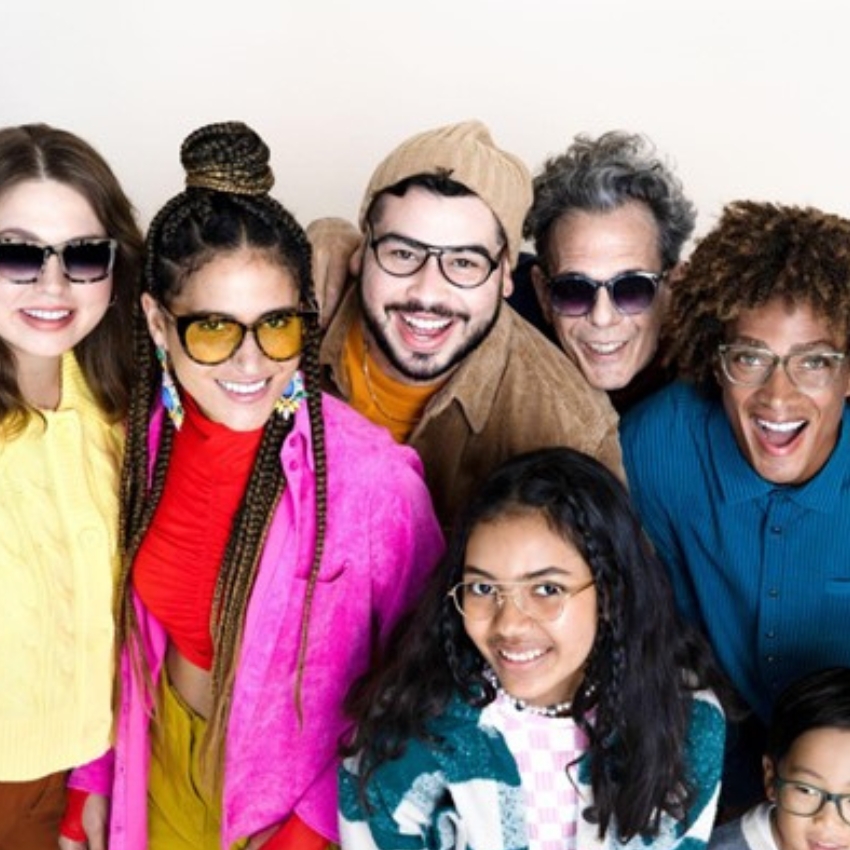 Group of smiling people wearing various styles of eyeglasses and sunglasses.