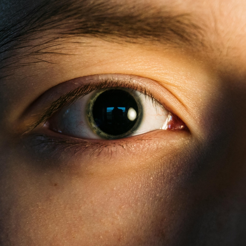 Close-up of a human eye with a large, dilated pupil.