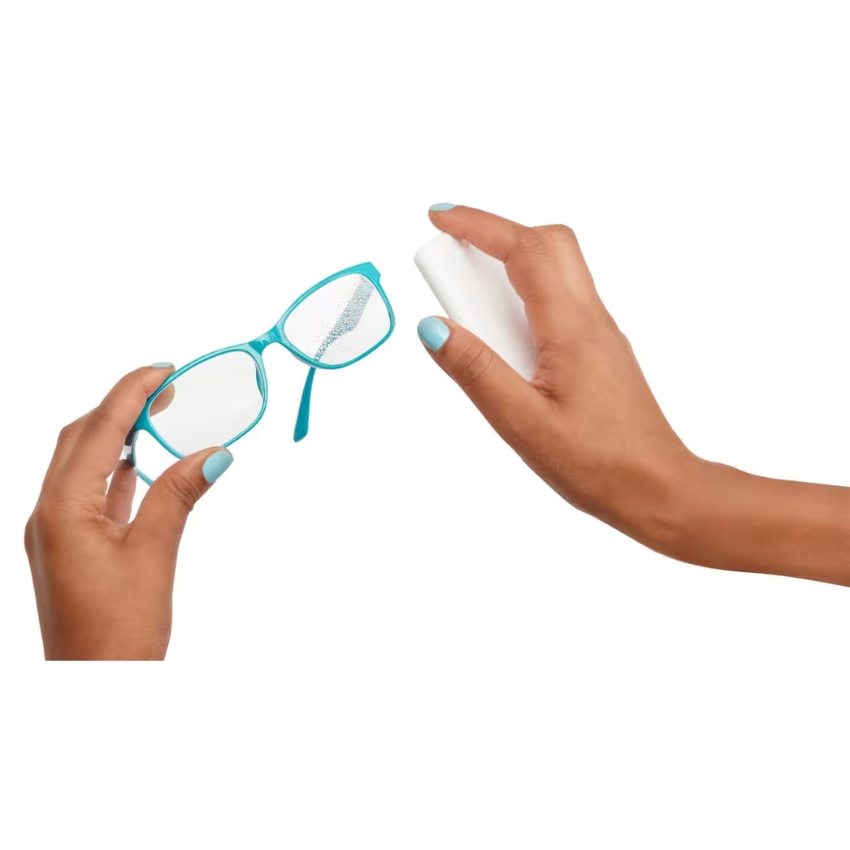 Turquoise-framed glasses and a hand holding a white spray bottle for cleaning.