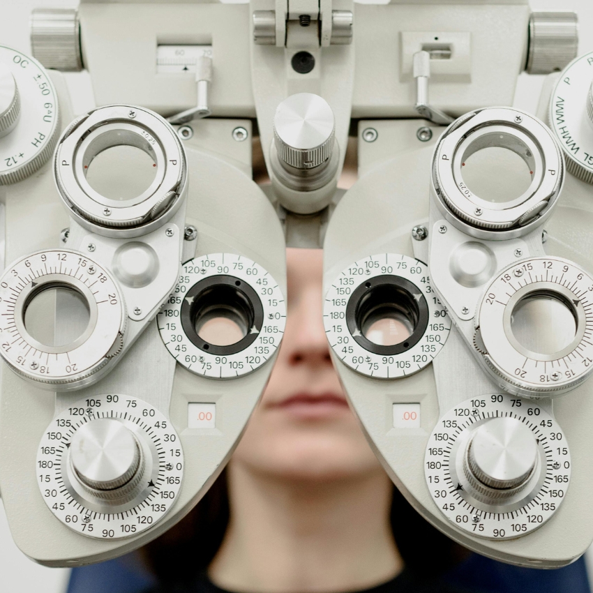 Phoropter with various lens dials and measurements for eye examination.