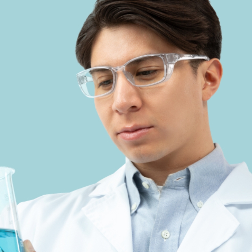 Clear safety glasses on a person in a lab coat.