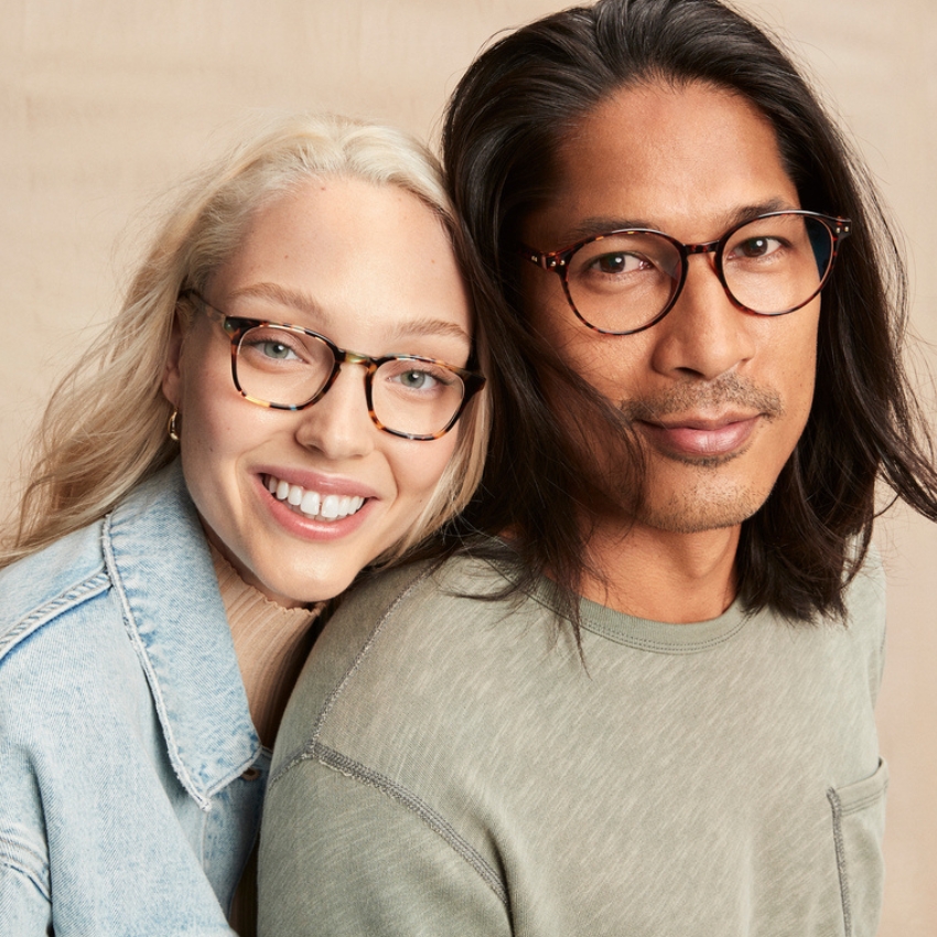 Two people wearing stylish tortoiseshell eyeglasses, one with round frames and the other with cat-eye frames.