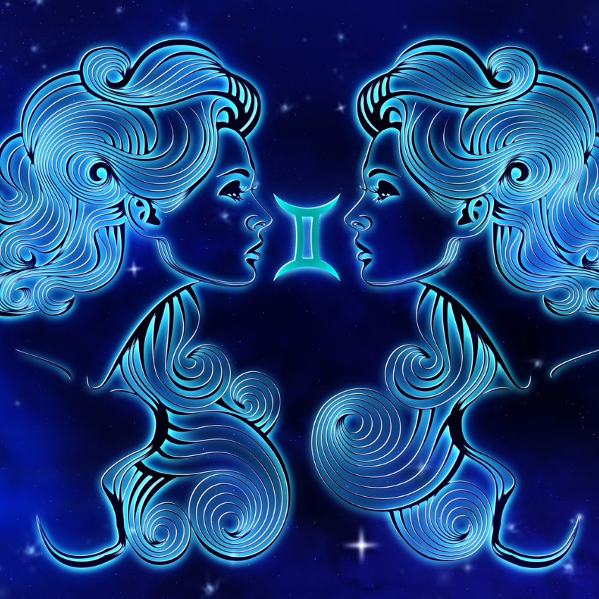 Two mirrored blue neon figures of women facing each other with the Gemini zodiac symbol between them.