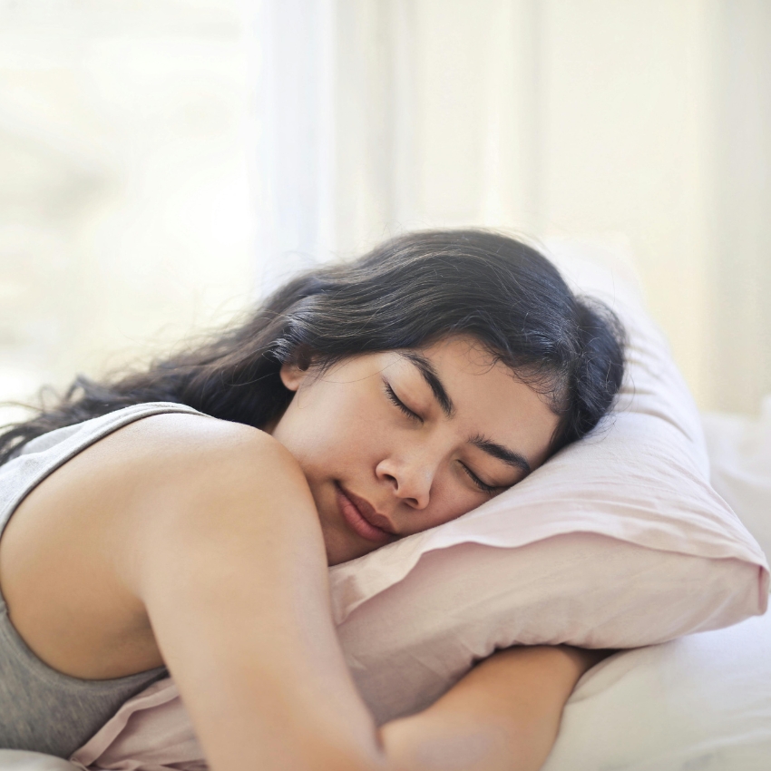 Woman sleeping on a pink pillow.