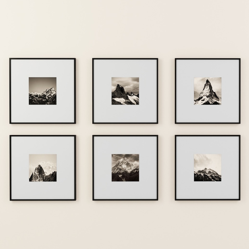 Set of six black and white mountain photographs in square black frames.