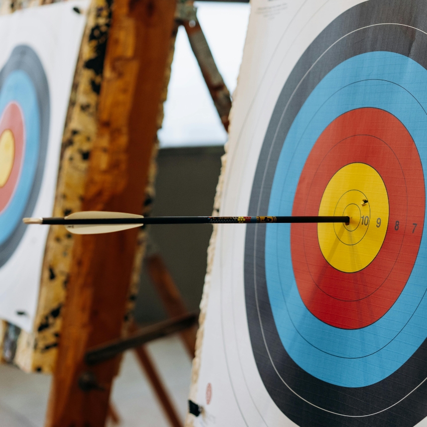 Arrow hitting the bullseye of an archery target.