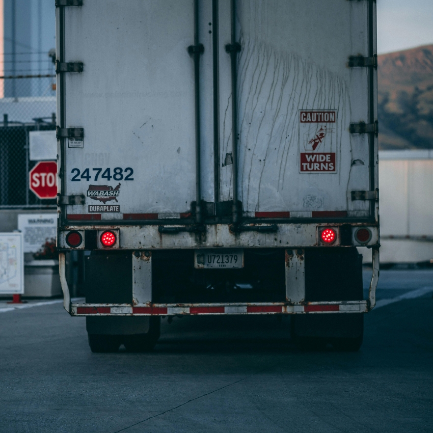 Back of a truck with license plate U721379 and caution sign "Wide Turns." Truck Number 247482.