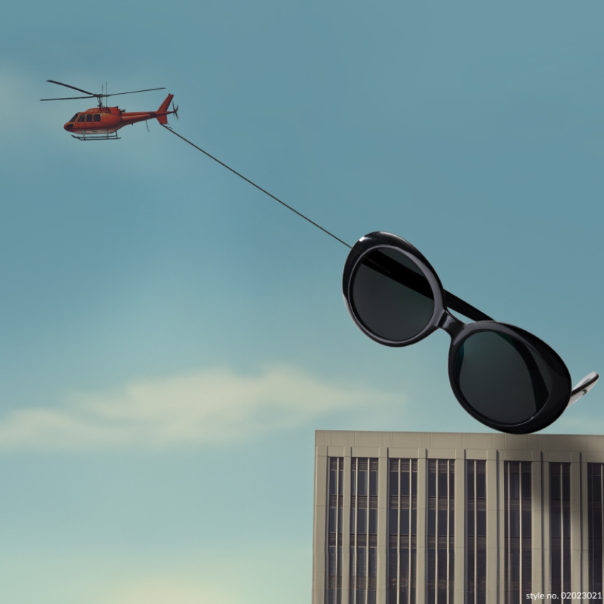 Large black sunglasses being carried by a red helicopter. Text: style no. 02023021.