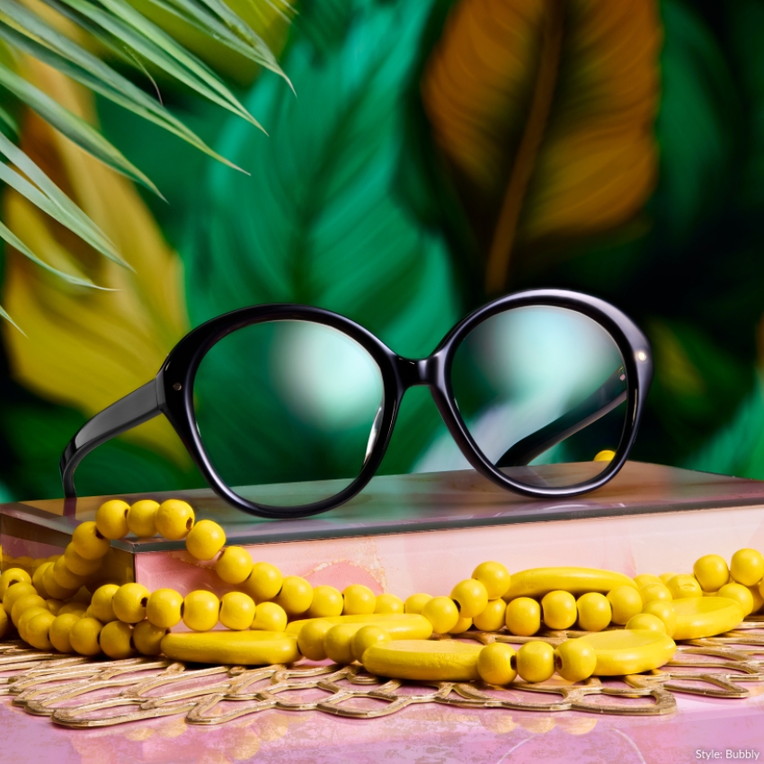 Black rounded eyeglasses with bright yellow beaded necklace. Text: "Style: Bubbly".