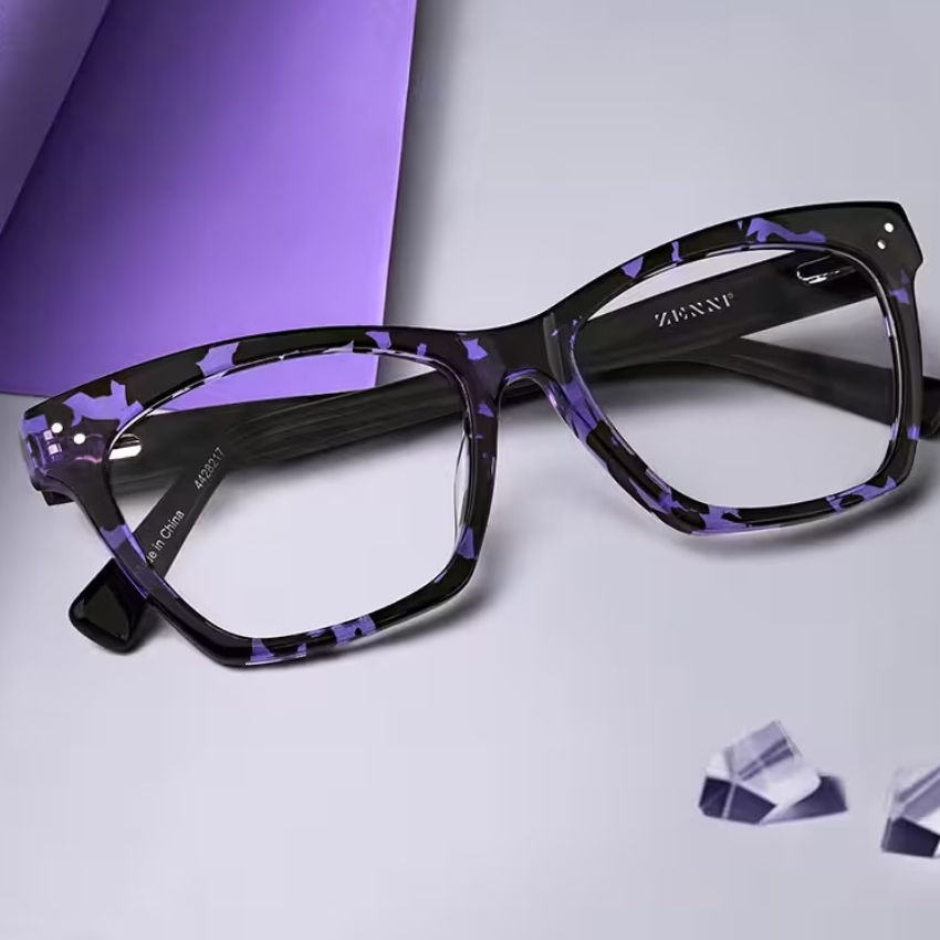 Purple and black marbled eyeglasses with "ZENNI" logo on the temple. "Made in China 412921" inside.