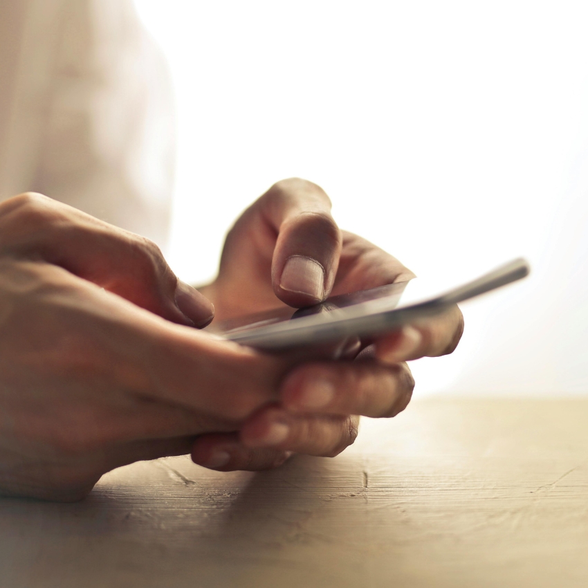 Hands holding a smartphone.