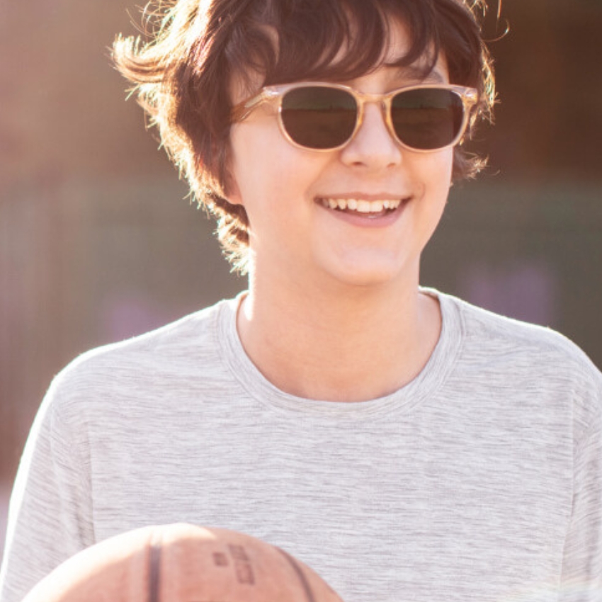 Brown sunglasses worn by a person with a basketball.