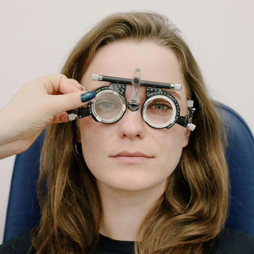 Woman wearing adjustable ophthalmic trial frame.