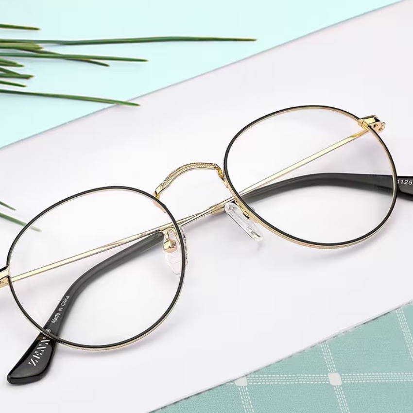 Round gold and black glasses with "ZANZ" and "Made in China" on the arms.