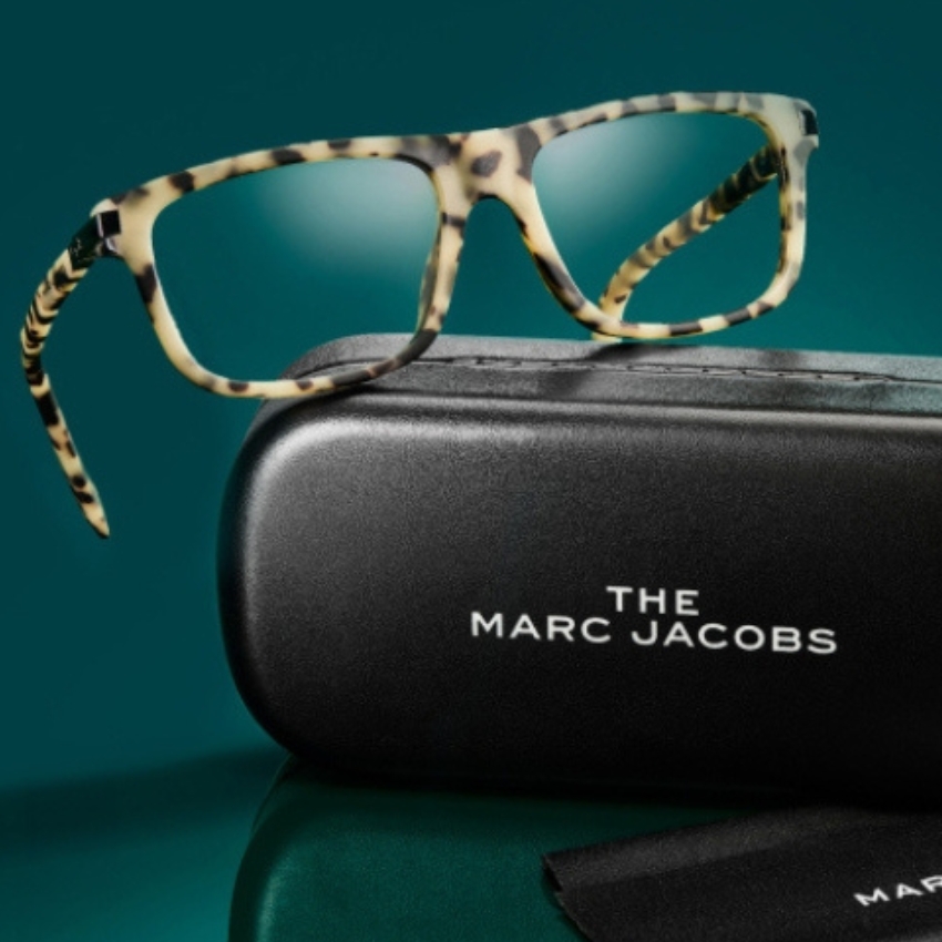 Tortoiseshell glasses with black case labeled "THE MARC JACOBS".