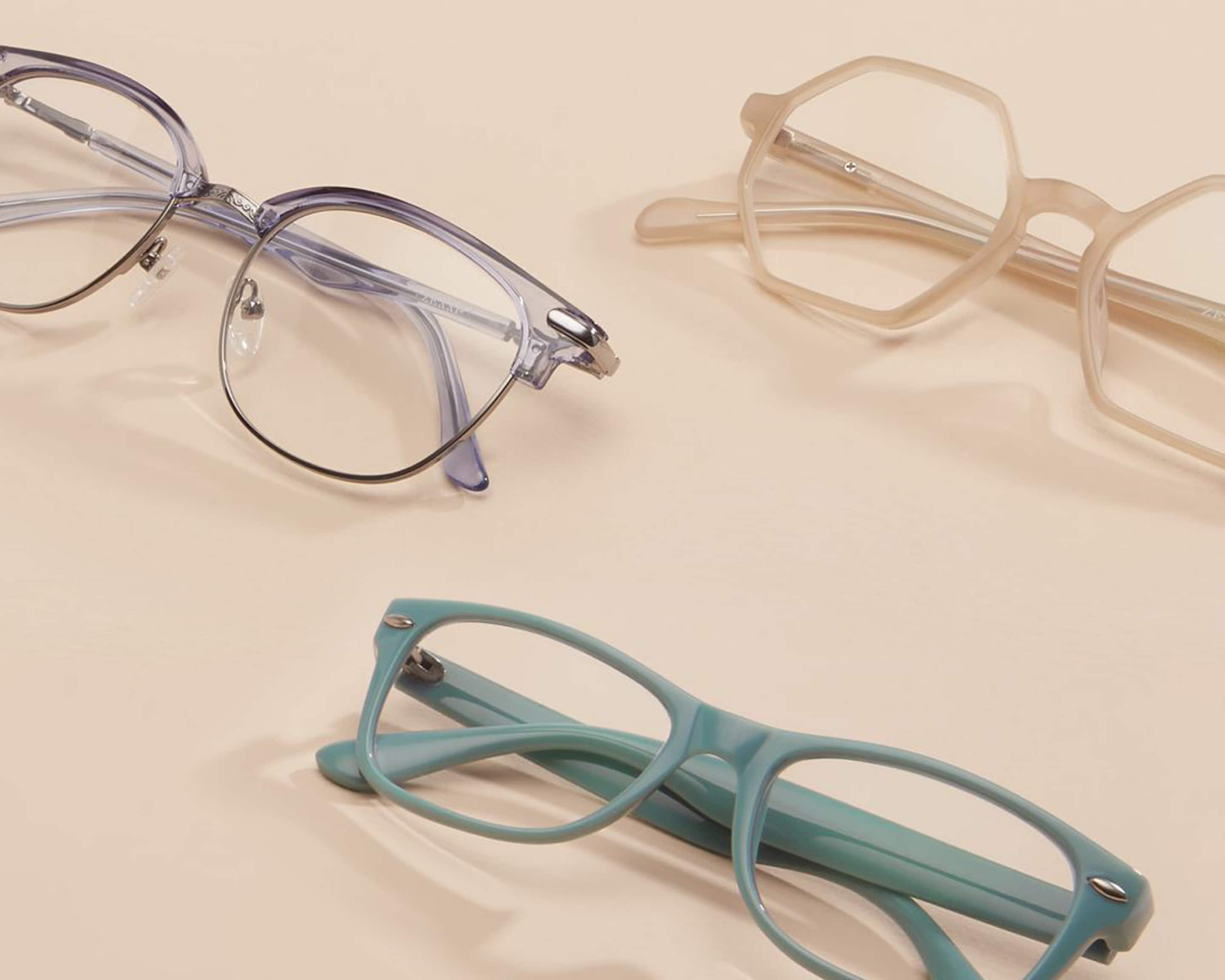 Image of three pairs of Zenni glasses against a beige-colored background.
