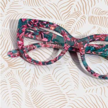 Cat-eye frames with pink flowers and green leaves.