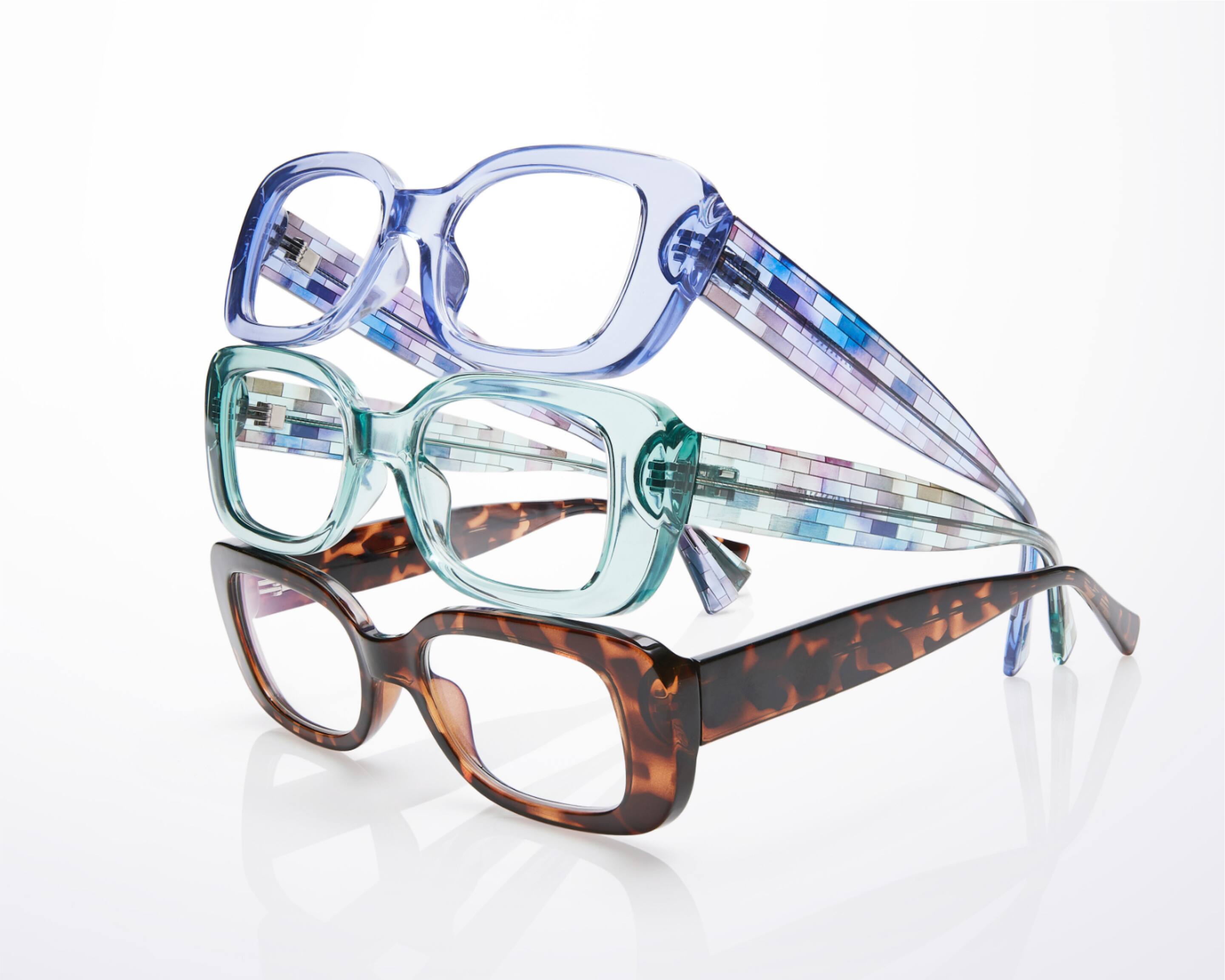 A stack of three rectangle glasses from bottom to top: tortoiseshell, clear green, clear blue.